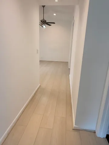 a view of a room with wooden floor