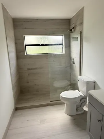 a bathroom with a toilet and a shower