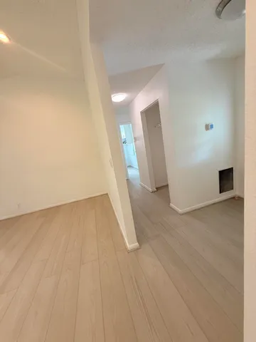 a view of a room with wooden floor