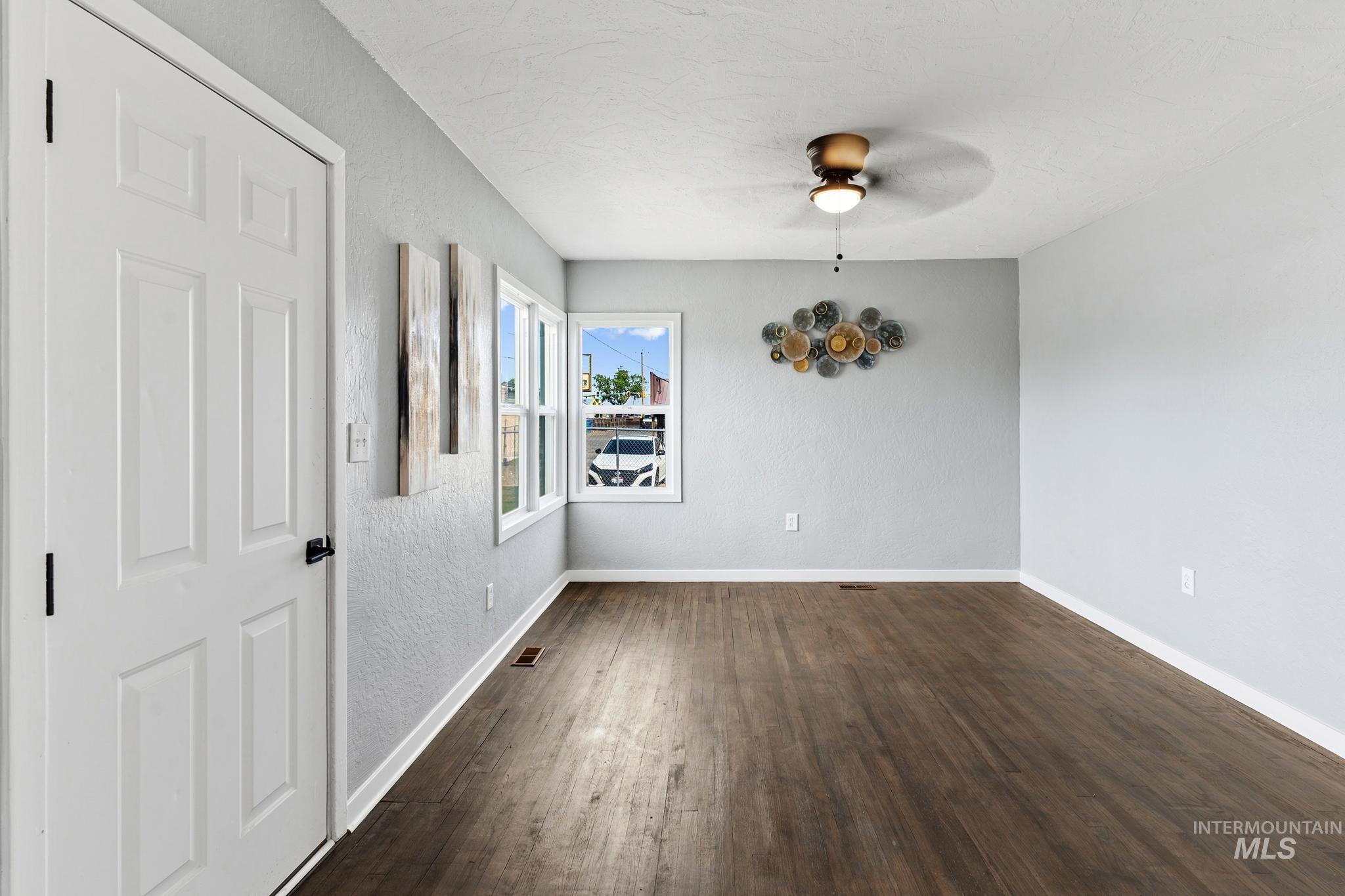 619 Thain Road Lewiston, ID 83501 - Photo 21 of 44 Open living area featuring wood-finish flooring, light grey walls, and a multi-pane window configuration