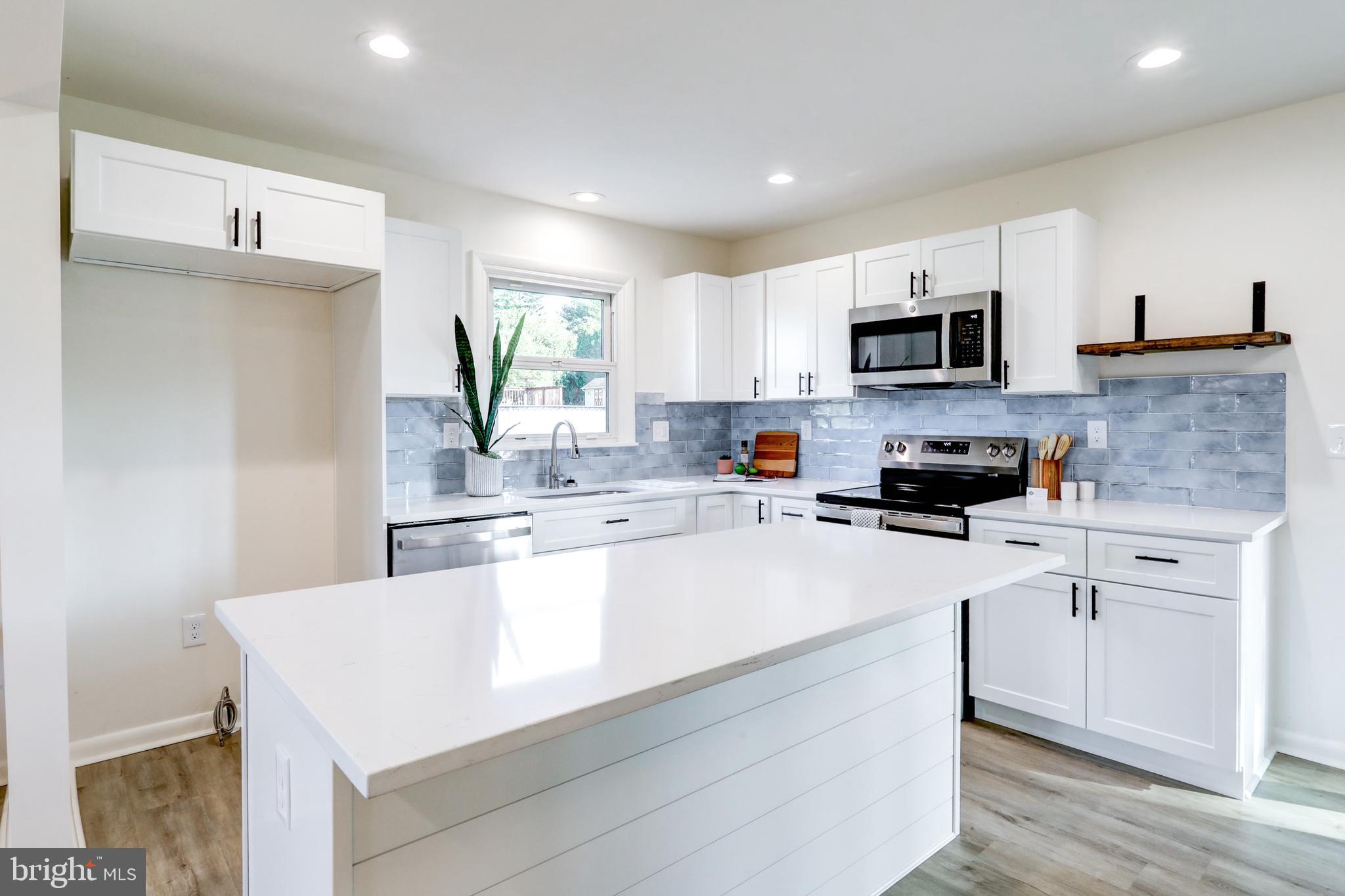 1198 Iron Bridge Road Columbia, PA 17512 - Photo 11 of 40 a kitchen with kitchen island a white counter top space cabinets and appliances