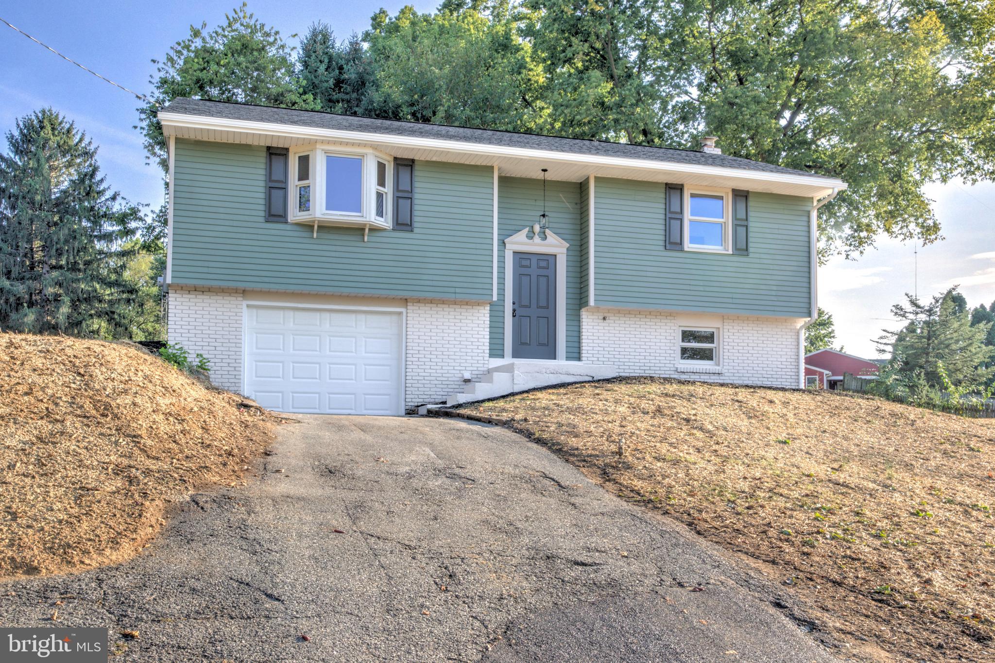 1198 Iron Bridge Road Columbia, PA 17512 - Photo 36 of 40 a front view of a house with a yard and garage
