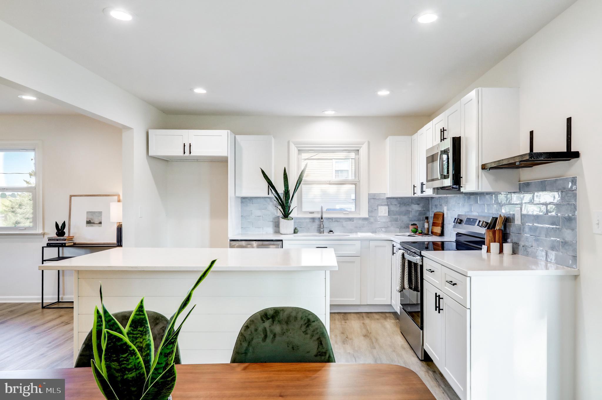1198 Iron Bridge Road Columbia, PA 17512 - Photo 9 of 40 a kitchen with white cabinets and wooden floor