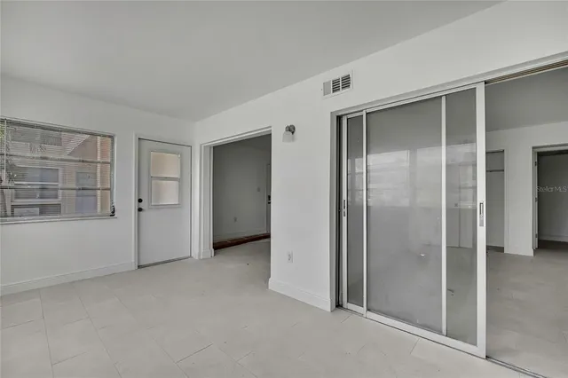 a white toilet sitting next to a white cabinet