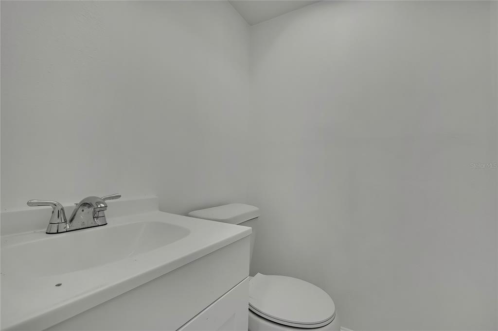 5242 Opal Lane, Unit 106 New Port Richey, FL 34652 - Photo 18 of 22 a bathroom with a sink a toilet and mirror