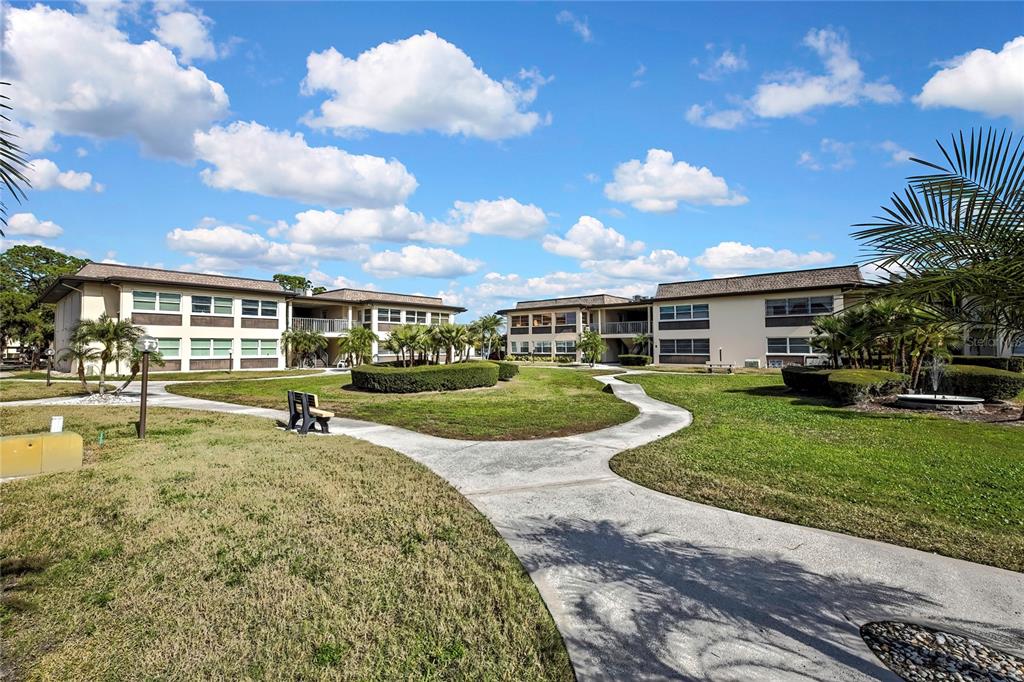 5242 Opal Lane, Unit 106 New Port Richey, FL 34652 - Photo 19 of 22 a view of a house with a swimming pool