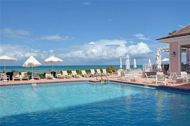 a view of a tennis court with trees in the background