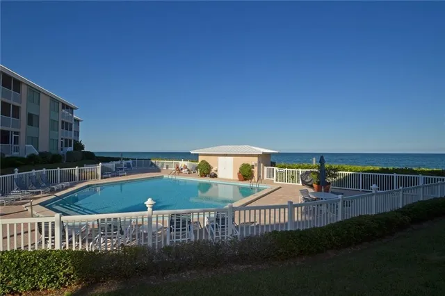 a view of a house with backyard porch and sitting area