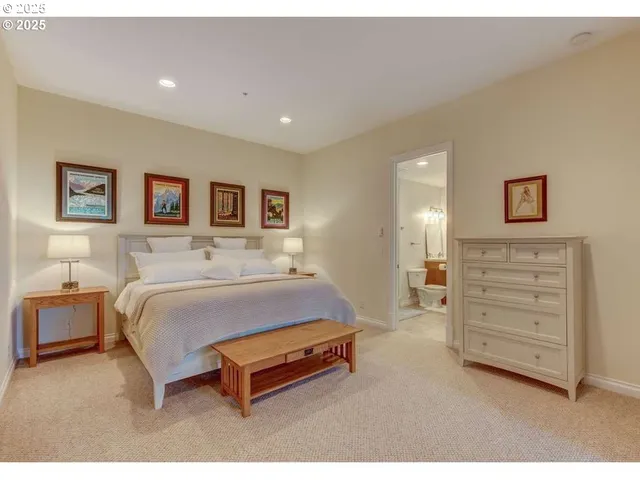 a spacious bedroom with a bed and dresser