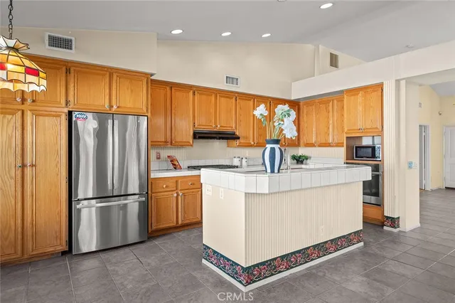 a kitchen with stainless steel appliances a refrigerator sink and cabinets