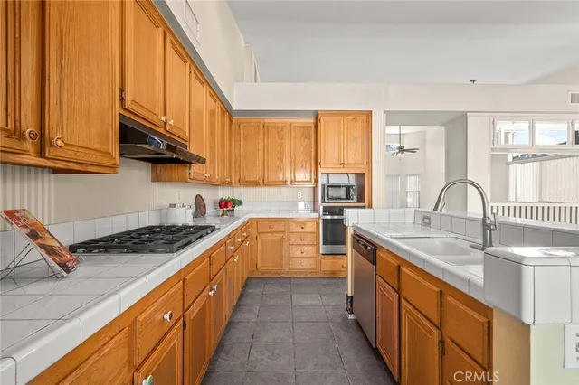a kitchen with stainless steel appliances granite countertop a sink stove and cabinets