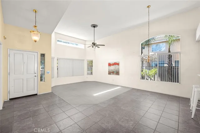 a view of a room with a windows and ceiling fan