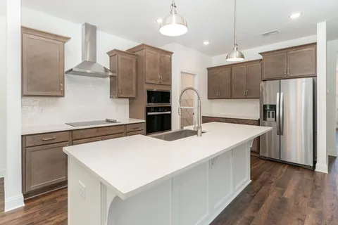 a kitchen with stainless steel appliances a stove refrigerator sink and microwave