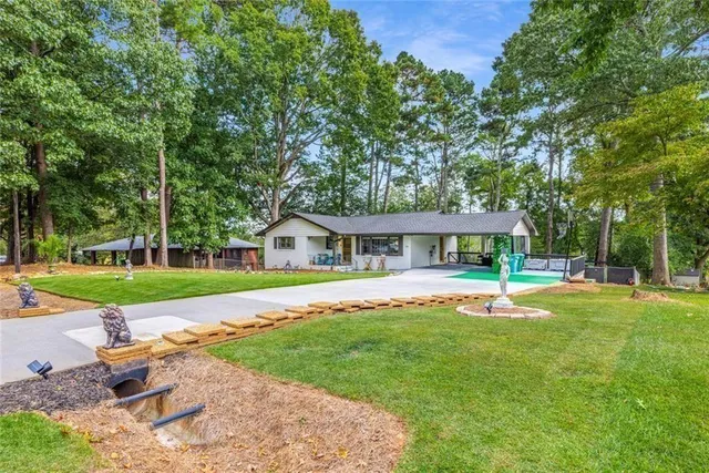 a view of a house with a yard patio and swimming pool