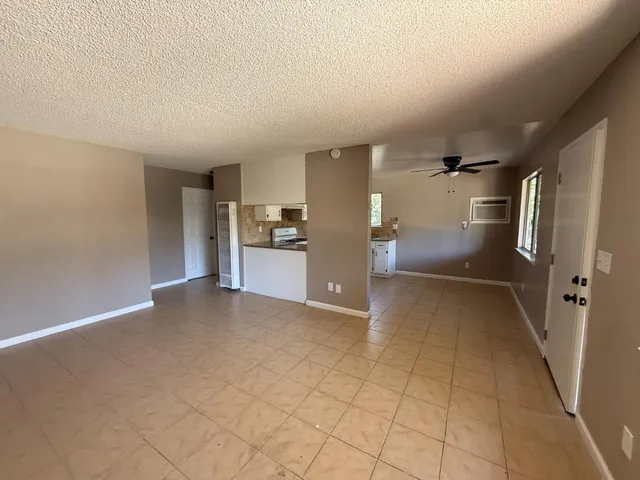 a view of a refrigerator in kitchen and a livingroom