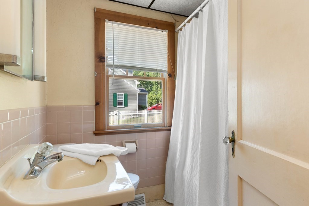 170 County Road Ipswich, MA 01938 - Photo 19 of 41 a bathroom with a sink a window and a mirror