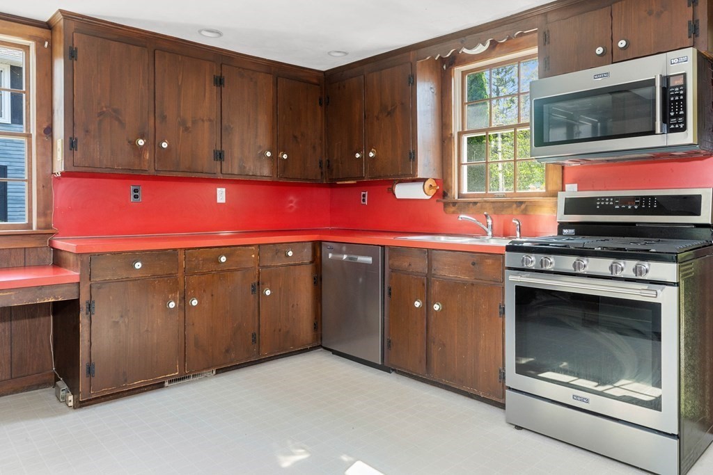170 County Road Ipswich, MA 01938 - Photo 3 of 41 a kitchen with stainless steel appliances granite countertop wooden cabinets a stove and a window