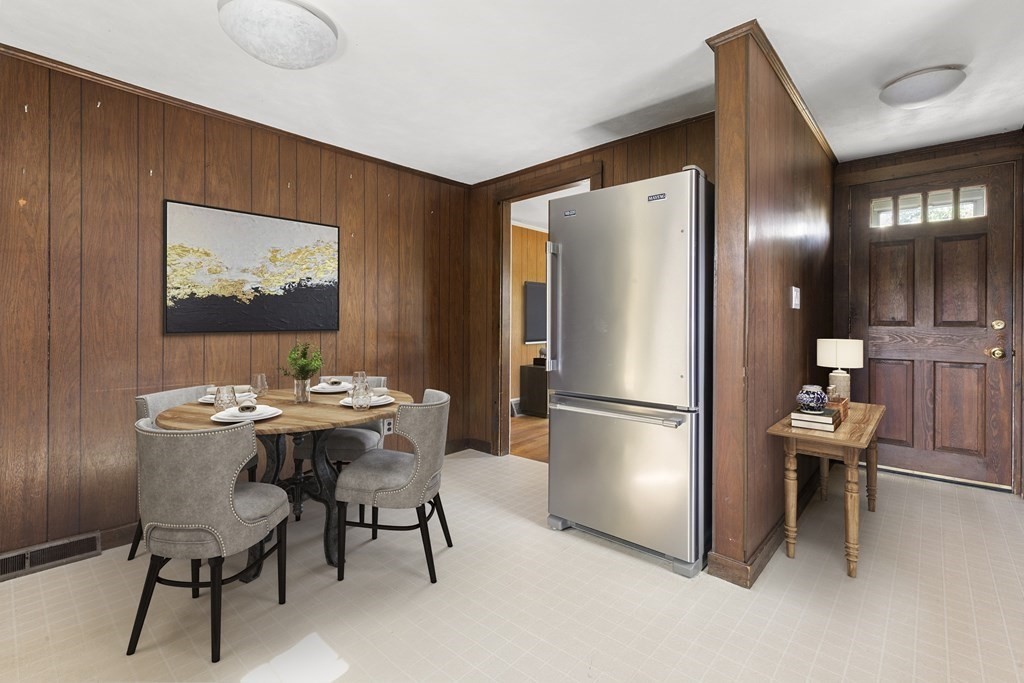 170 County Road Ipswich, MA 01938 - Photo 6 of 41 a kitchen with stainless steel appliances a refrigerator a sink a dining table and chairs