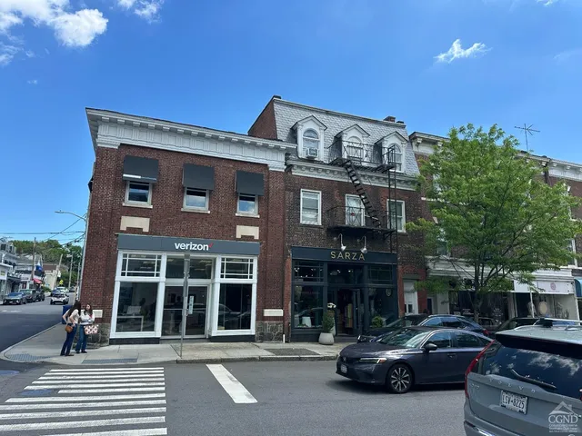 a couple of cars parked in front of a building