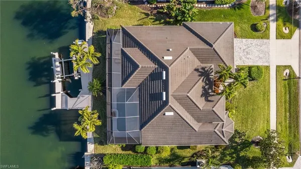 an aerial view of a house with swimming pool and garden