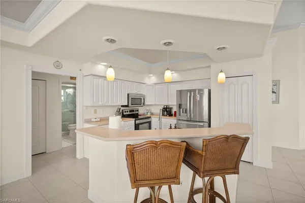 a kitchen with stainless steel appliances kitchen island granite countertop a sink and cabinets