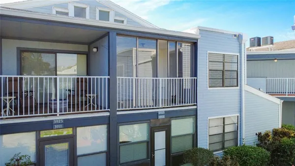 a view of a house with a small deck
