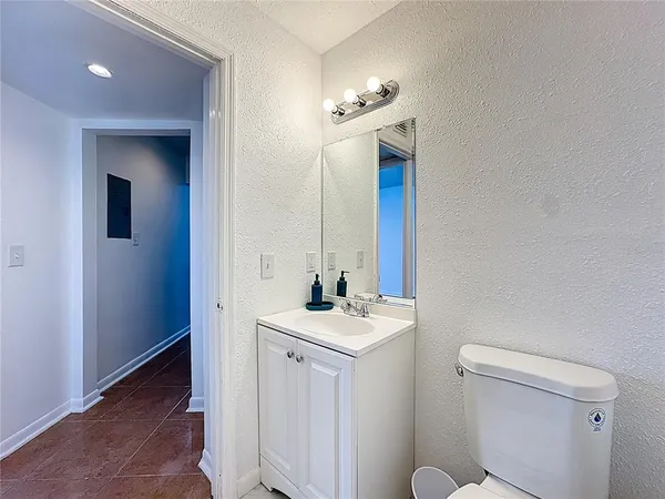 a bathroom with a sink vanity and a toilet
