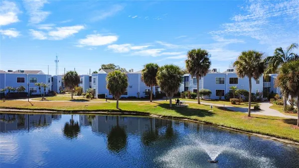 a view of a swimming pool with outdoor seating