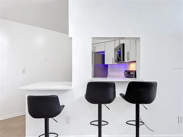 a living room with furniture and a lamp