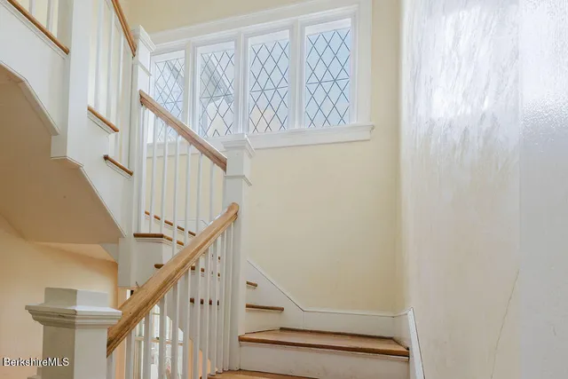 a view of a hallway with wooden floor and entryway