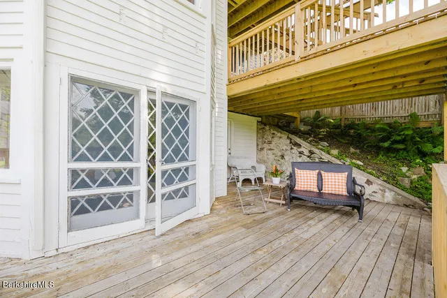a view of house with yard and seating area