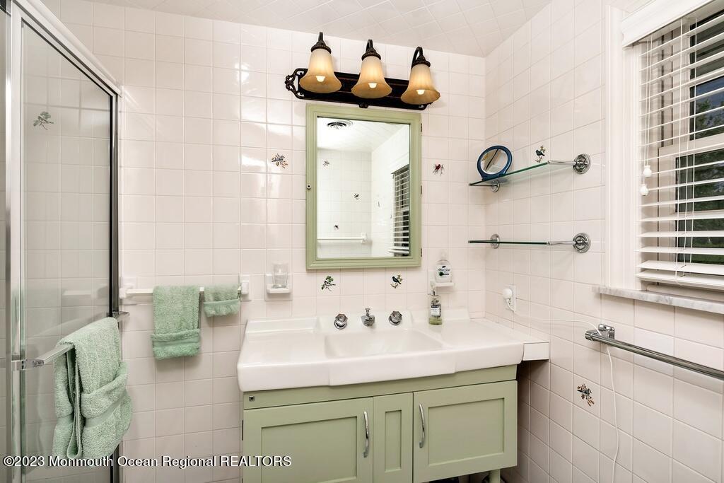 127 Curtis Point Drive Mantoloking, NJ 08738 - Photo 13 of 34 a bathroom with a sink and a mirror