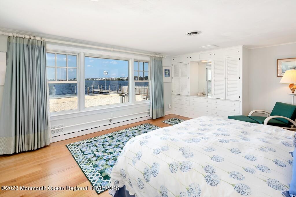 127 Curtis Point Drive Mantoloking, NJ 08738 - Photo 14 of 34 a bedroom with a bed and glass window