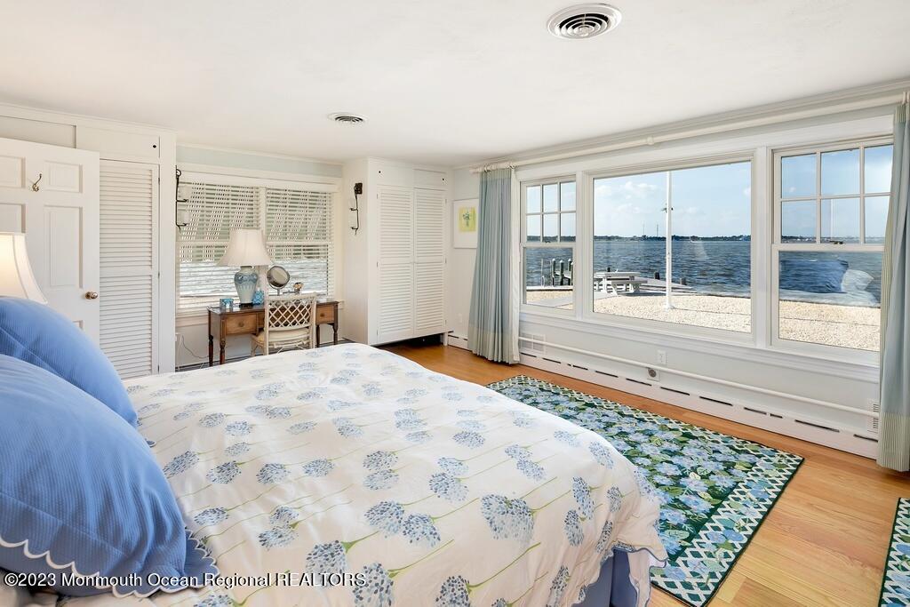 127 Curtis Point Drive Mantoloking, NJ 08738 - Photo 15 of 34 a bedroom with a bed and a large window