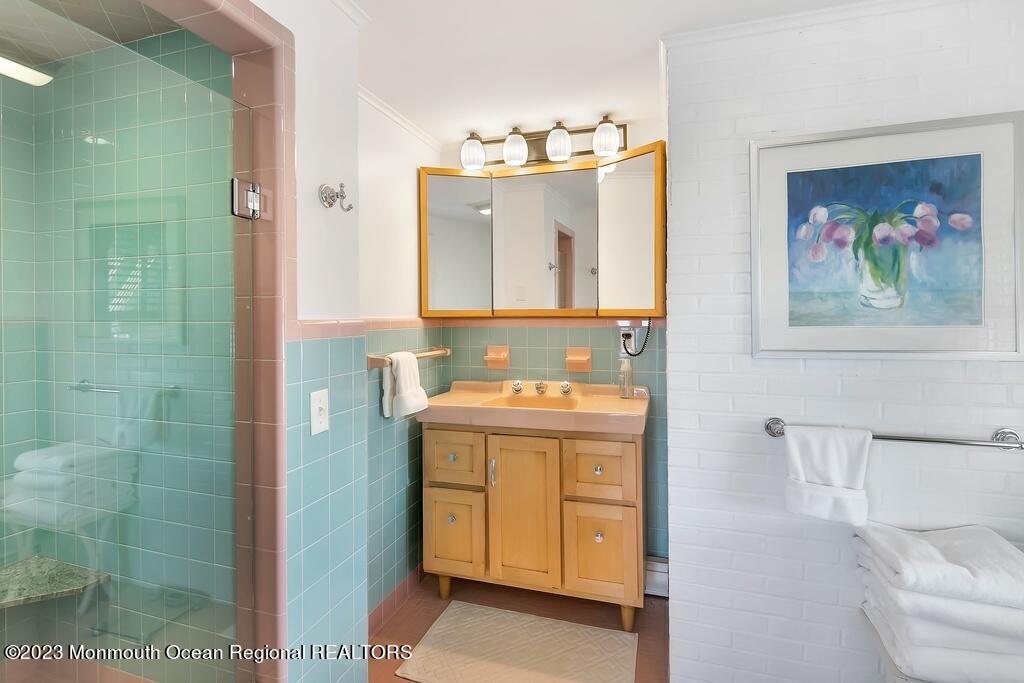 127 Curtis Point Drive Mantoloking, NJ 08738 - Photo 16 of 34 a bathroom with a sink mirror and vanity