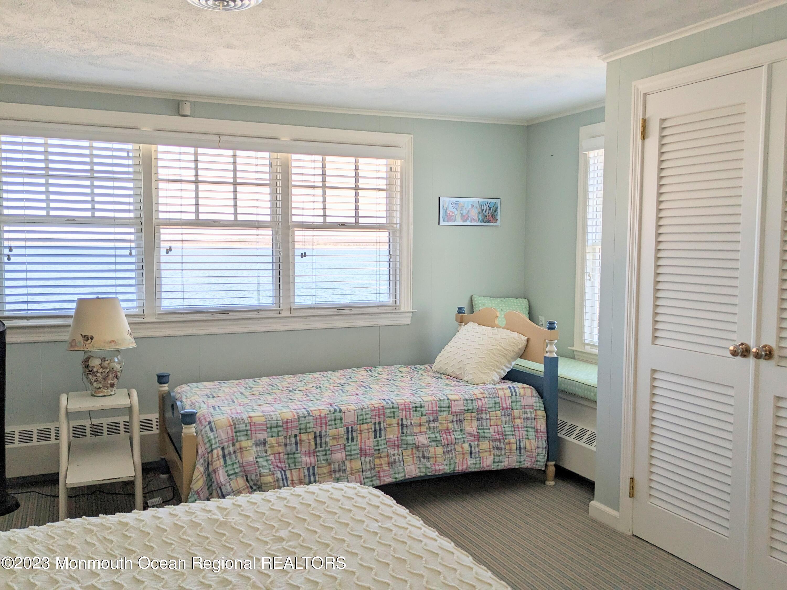 127 Curtis Point Drive Mantoloking, NJ 08738 - Photo 19 of 34 a bedroom with a bed and wooden floor