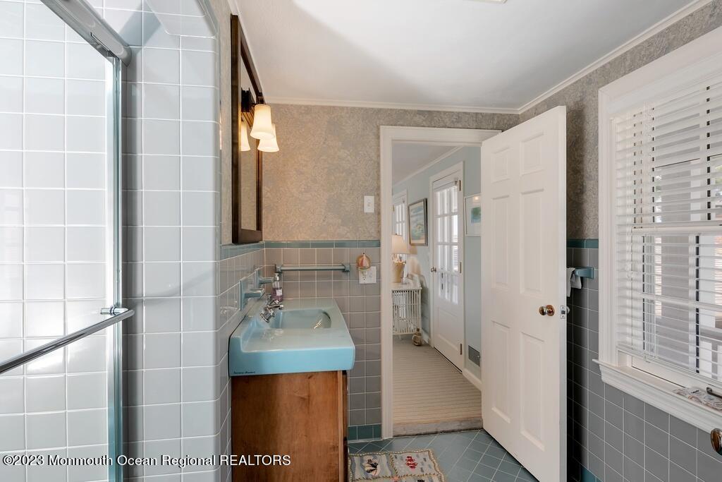127 Curtis Point Drive Mantoloking, NJ 08738 - Photo 20 of 34 a bathroom with a double vanity sink and mirror