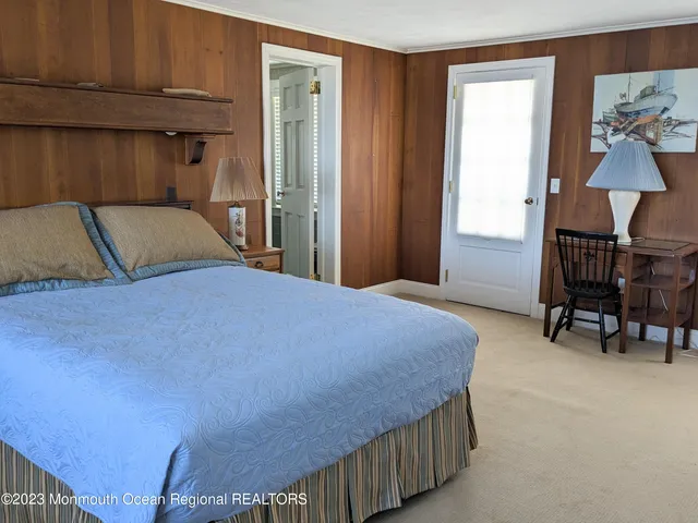 a bedroom with a bed and windows