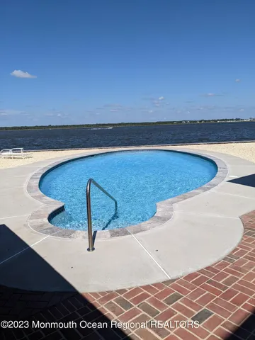 a view of a dining room with furniture large windows and wooden floor