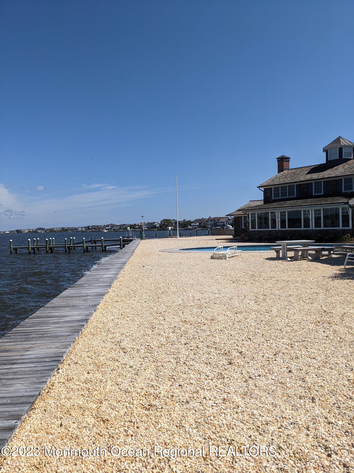 127 Curtis Point Drive Mantoloking, NJ 08738 - Photo 29 of 34 a view of swimming pool with outdoor seating and yard in the back