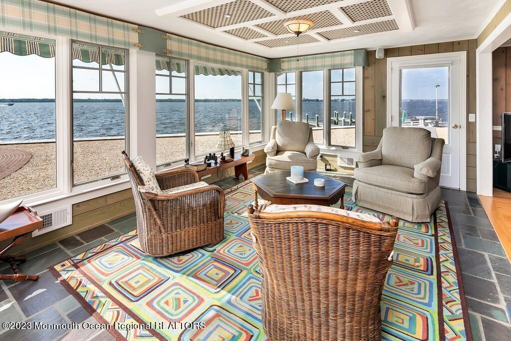127 Curtis Point Drive Mantoloking, NJ 08738 - Photo 8 of 34 a living room with furniture and a floor to ceiling window