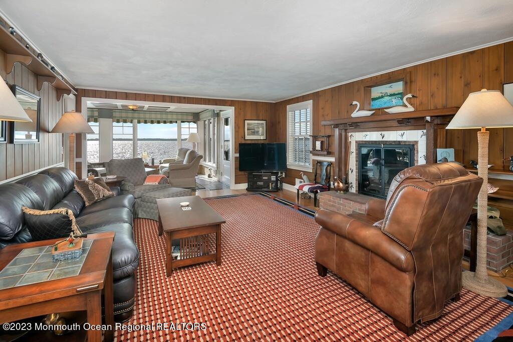 127 Curtis Point Drive Mantoloking, NJ 08738 - Photo 10 of 34 a living room with furniture a fireplace and a large window
