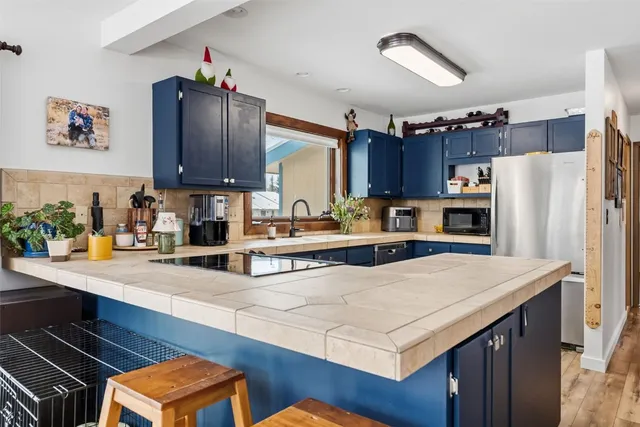 a kitchen with a refrigerator a stove a sink and a counter space