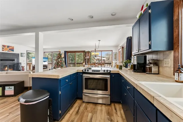 a kitchen with stainless steel appliances granite countertop a sink a stove and a refrigerator