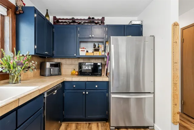 a kitchen with stainless steel appliances a refrigerator and a sink