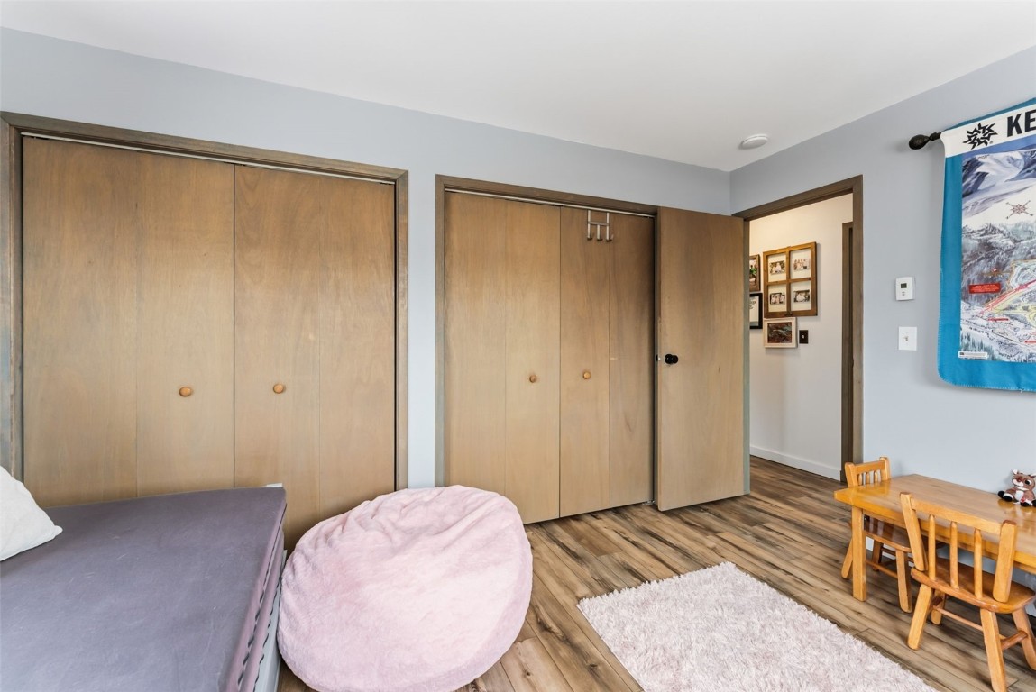 460 Clayton Road Silverthorne, CO 80498 - Photo 21 of 50 a bedroom with a bed and wooden floor
