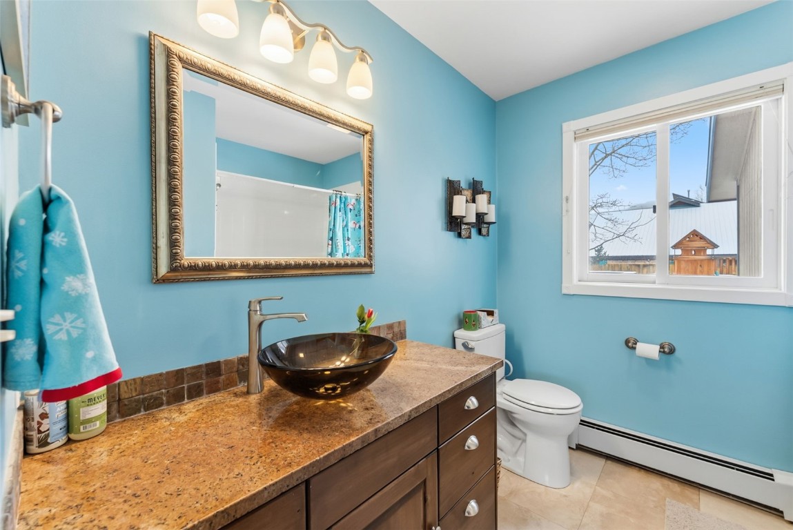 460 Clayton Road Silverthorne, CO 80498 - Photo 26 of 50 a bathroom with a toilet a sink and mirror