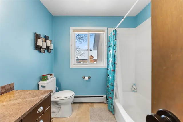 a bathroom with a toilet sink and tub