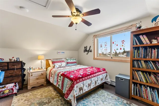 a bedroom with a bed a book shelf and a book shelf