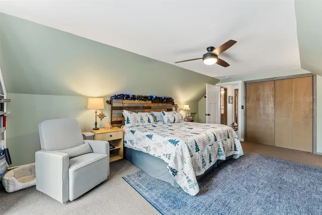 a spacious bedroom with a bed and a chandelier